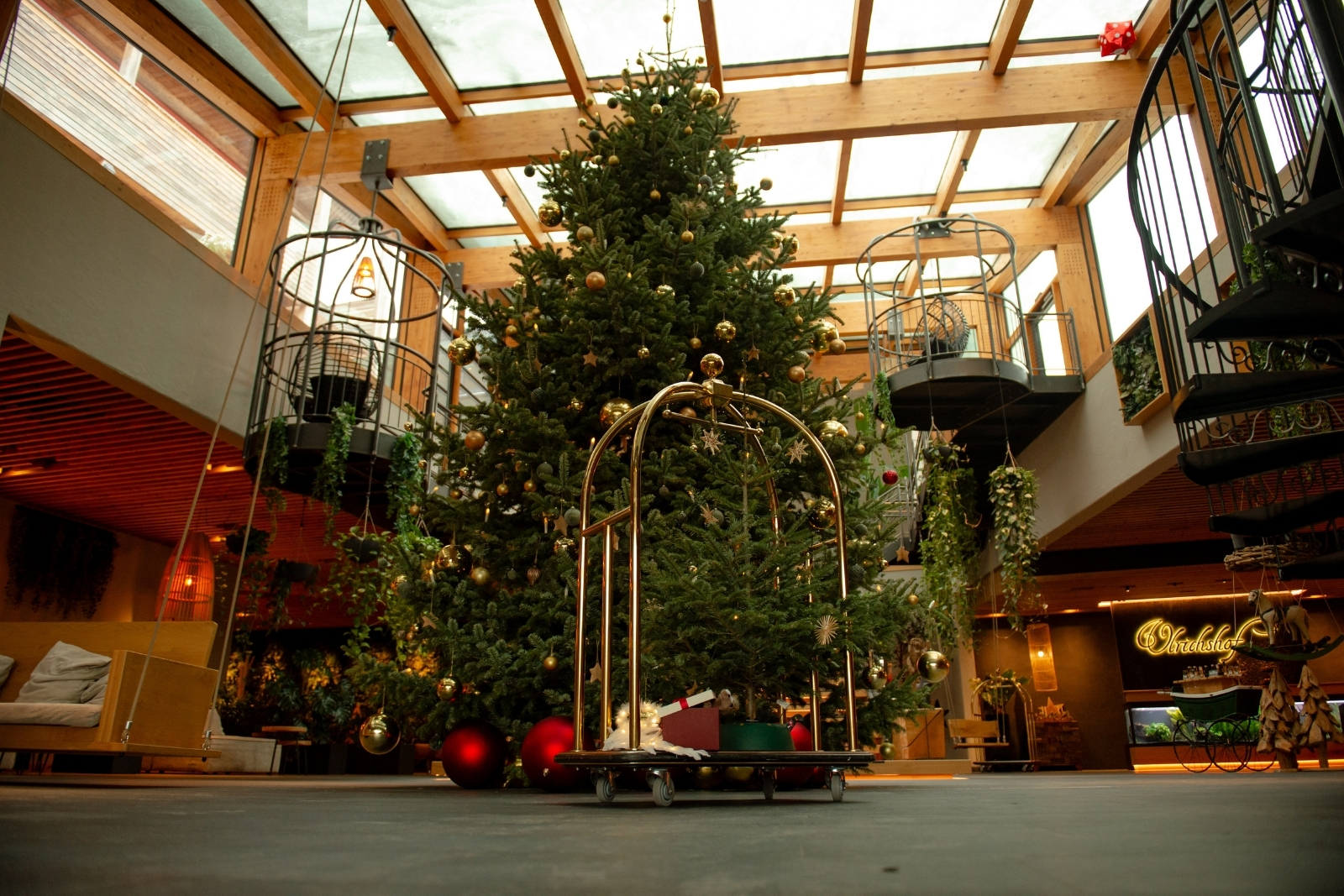 A large christmas tree sits in a hotel lobby.